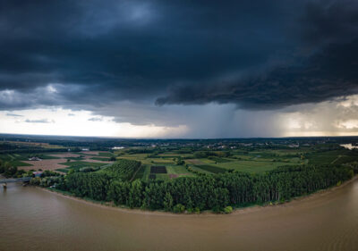 The river with a storm and a rain in the summer, Garonne river, Gironde, France