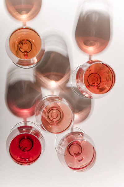 Flat lay of several wine glasses over white table