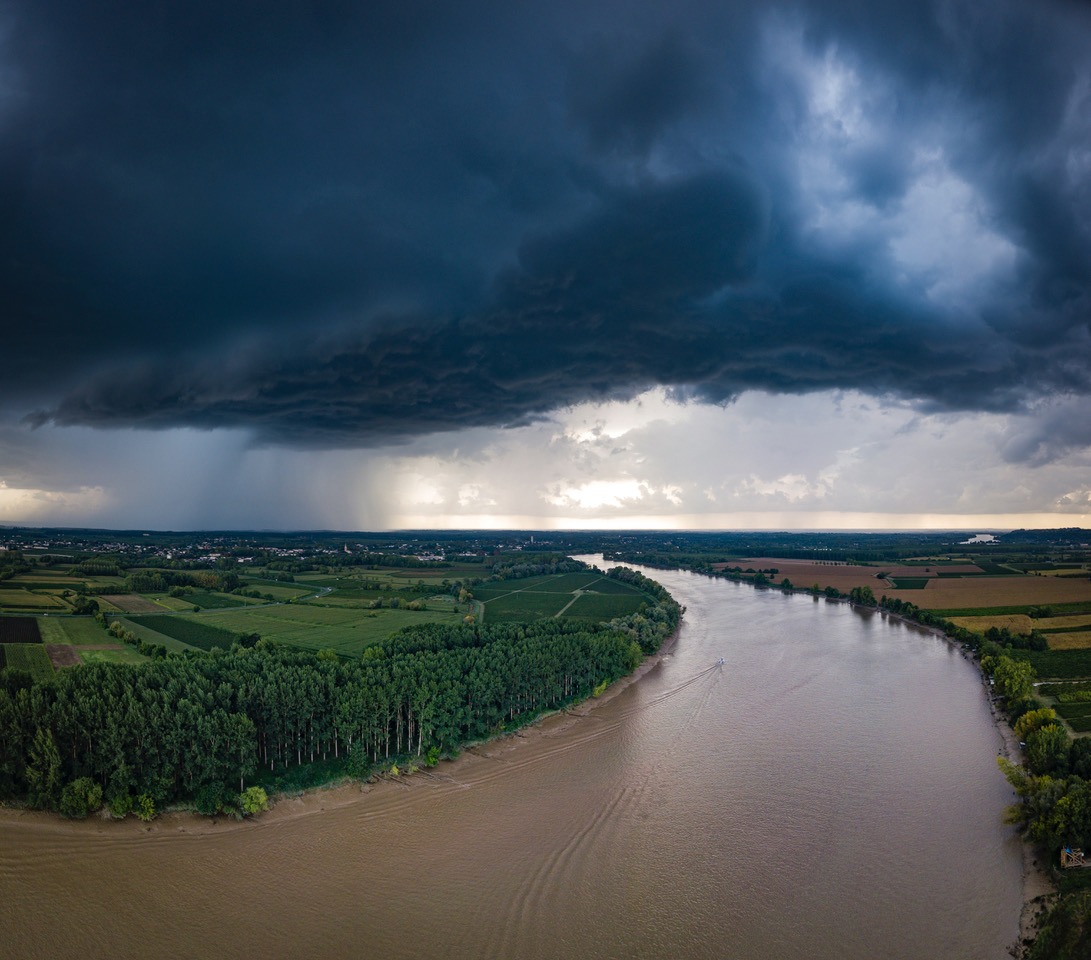 The river with a storm and a rain in the summer, Garonne river, Gironde, France